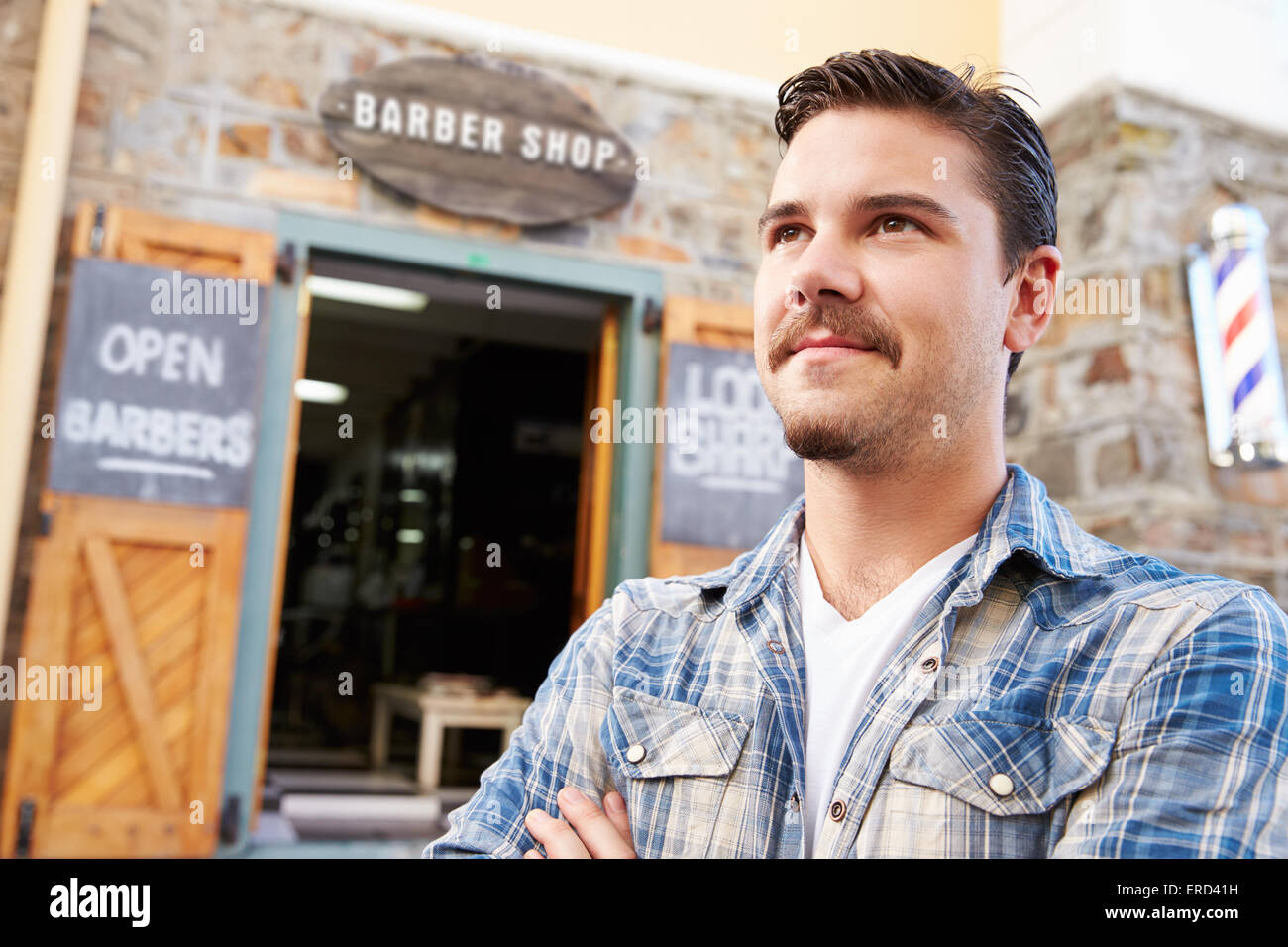 Portrait Of Hipster Barber Standing Outside Shop Stock Photo