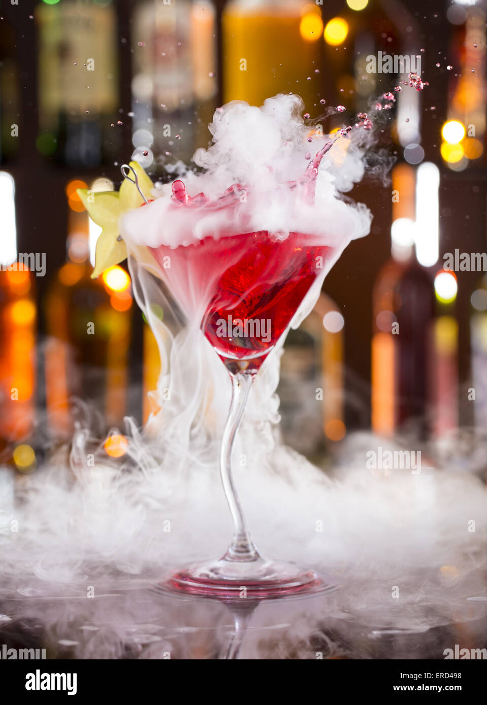Cocktail with ice vapor on bar desk, close-up. Stock Photo
