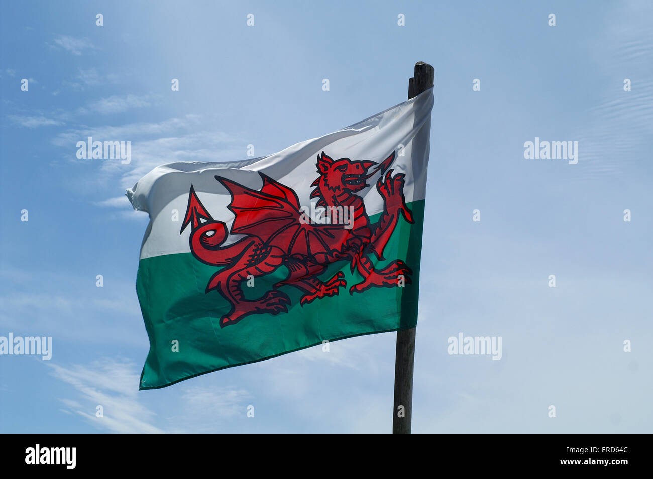 Welsh flag against a blue sky with clouds Stock Photo