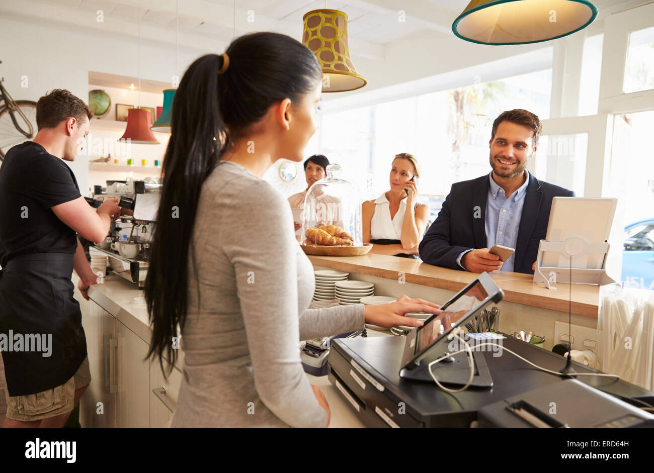 Young man ordering at the counter in a cafe Stock Photo Alamy