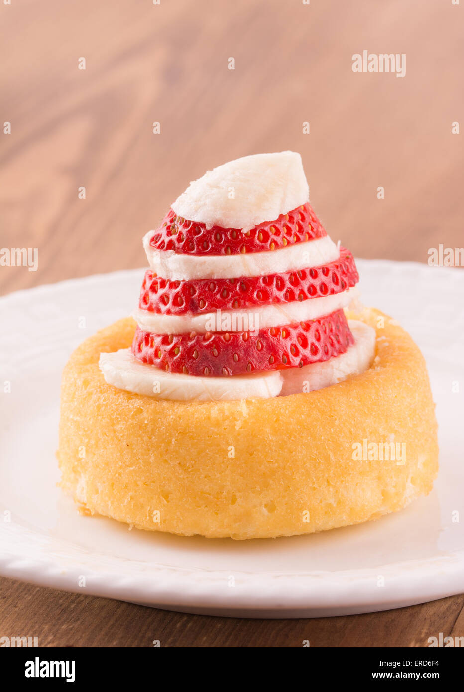 Dessert shell with sliced strawberry and banana, on a white plate Stock Photo