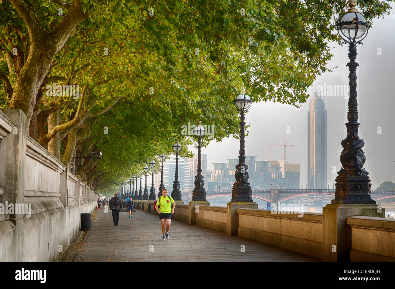 UK, England, London.  Early Morning Walkers and Joggers along the Jubilee Greenway, South Bank, Thames River. Stock Photo