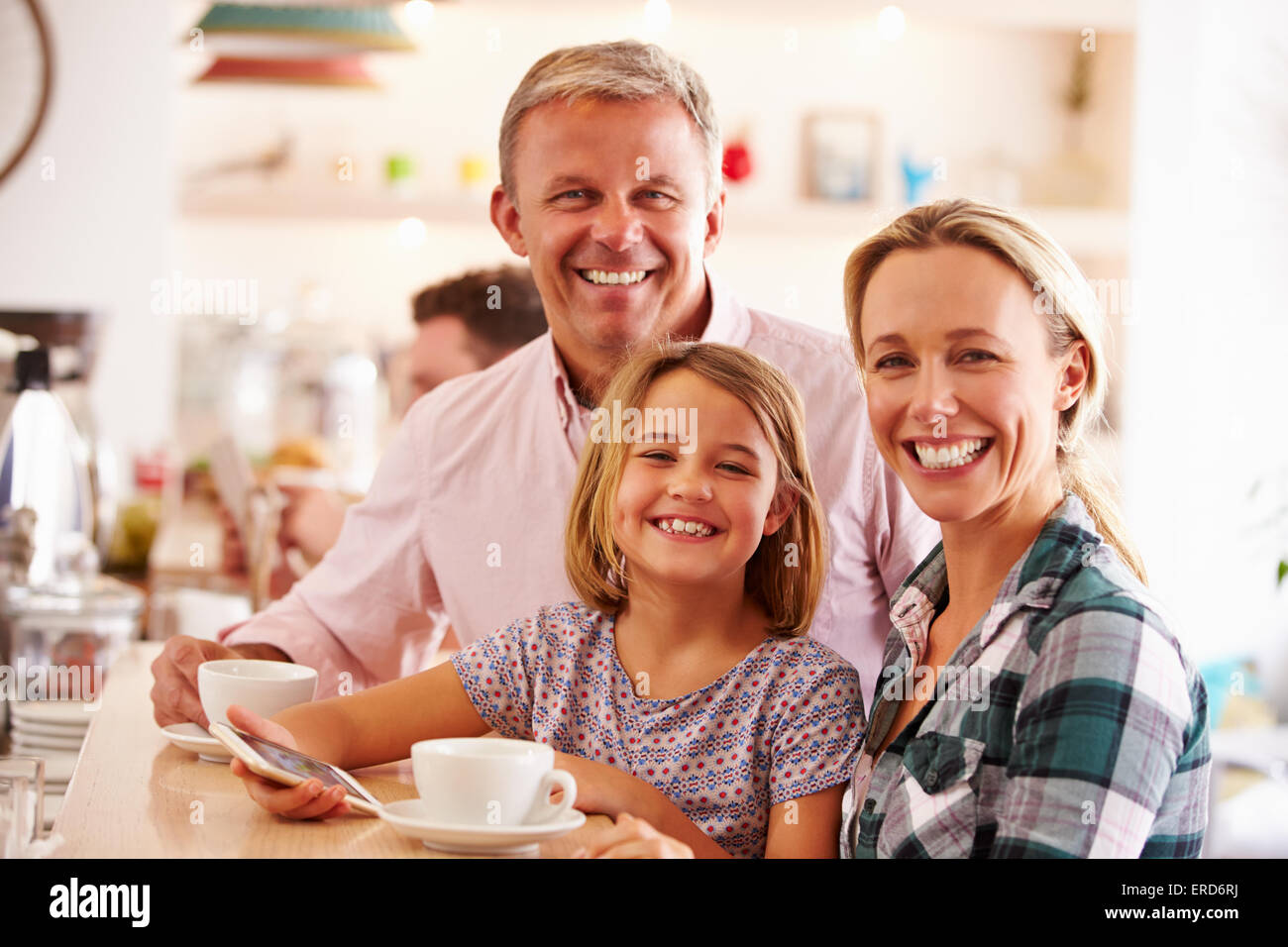 Happy family in a cafe Stock Photo - Alamy
