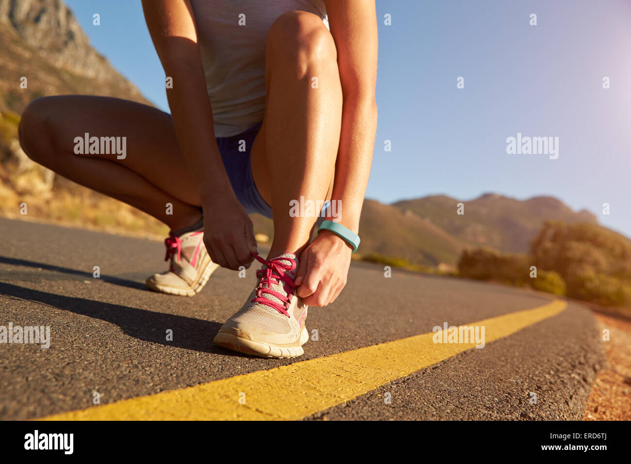 Cropped shot of female jogger doing up her shoe lace Stock Photo
