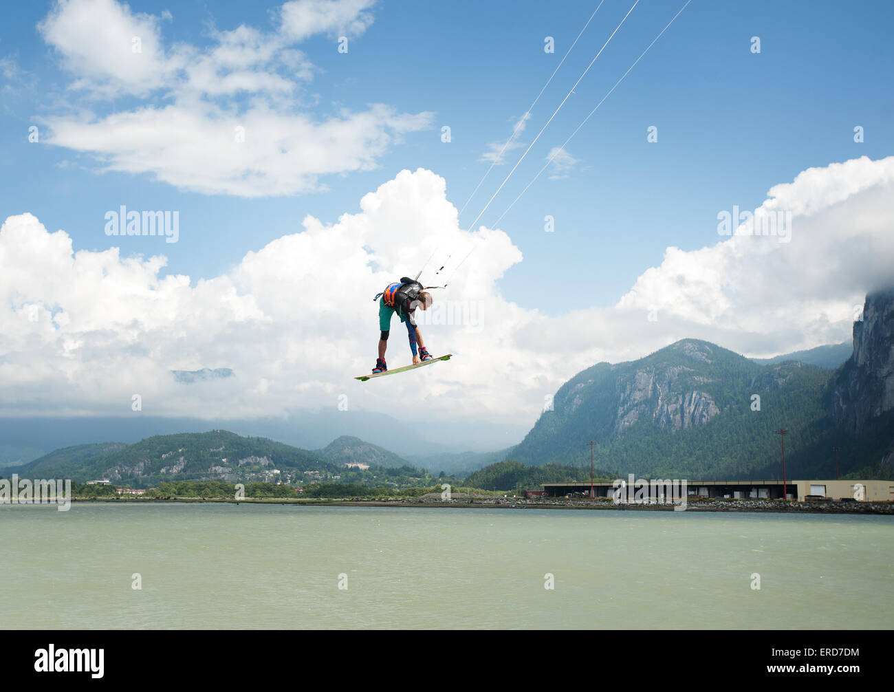 A kite boarder with takes huge air at the Squamish Spit kite boarding area.  Squamish BC, Canada. Stock Photo