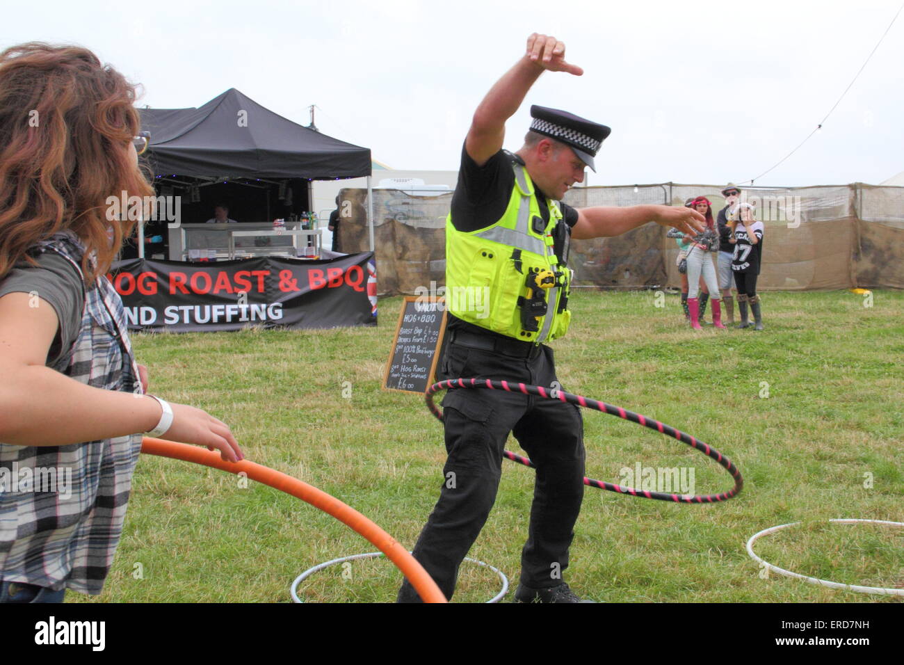 A Police Officer tries out hua hooping at the Y Not Festival, Peak District, England UK Stock Photo