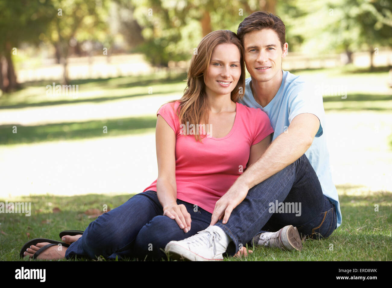 Couple Sitting in Park Stock Photo - Alamy