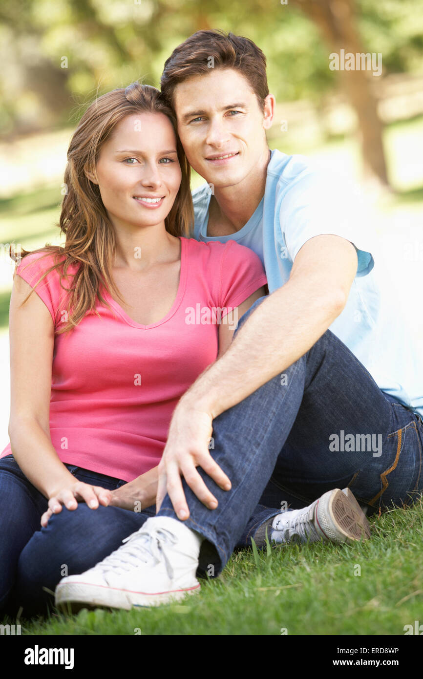 Couple Sitting in Park Stock Photo - Alamy