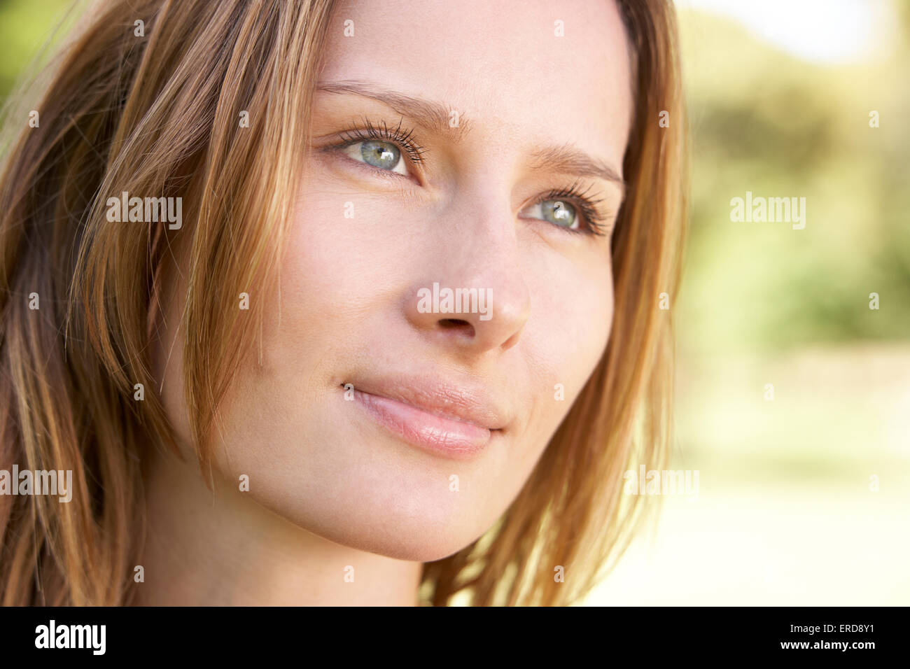 Portrait Of Attractive Young Woman Outdoors In Park Stock Photo - Alamy
