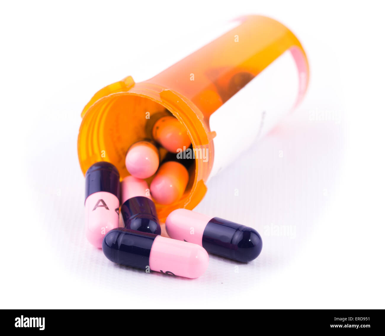Antibiotics spilling out of a prescription bottle, on white background Stock Photo