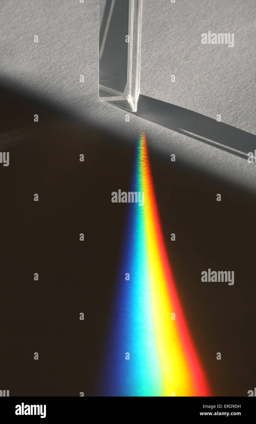 Light refraction generating a rainbow from a glass prism Stock Photo