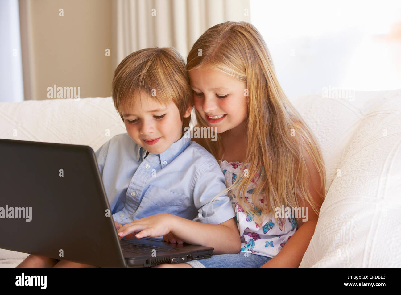 Two Young Children Using Laptop At Home Stock Photo - Alamy