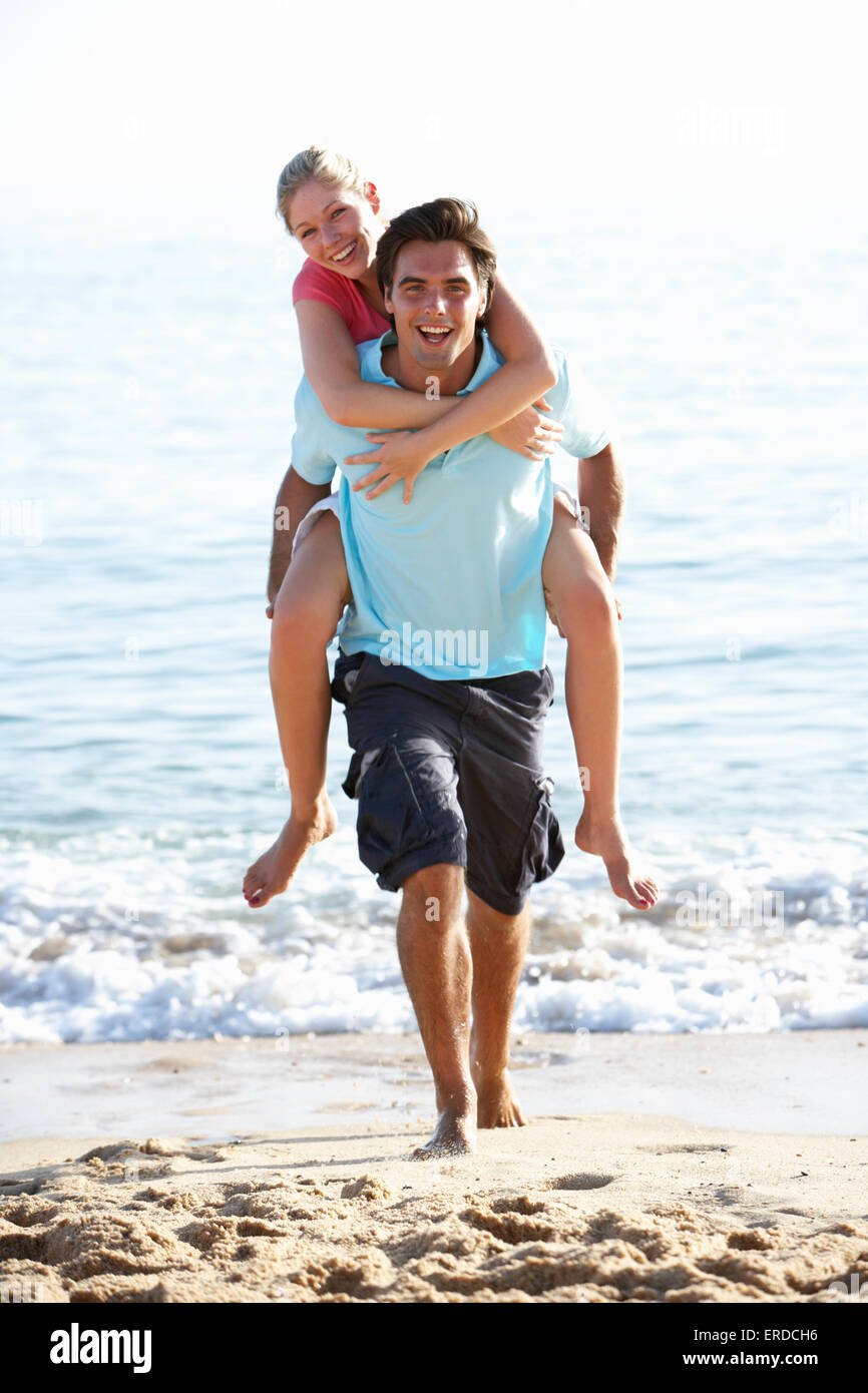 Couple piggyback beach hi-res stock photography and images - Alamy
