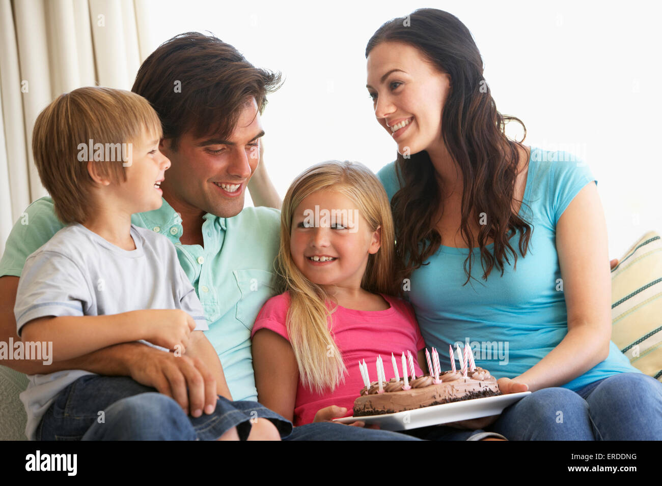 Family Group Celebrating Birthday At Home Stock Photo