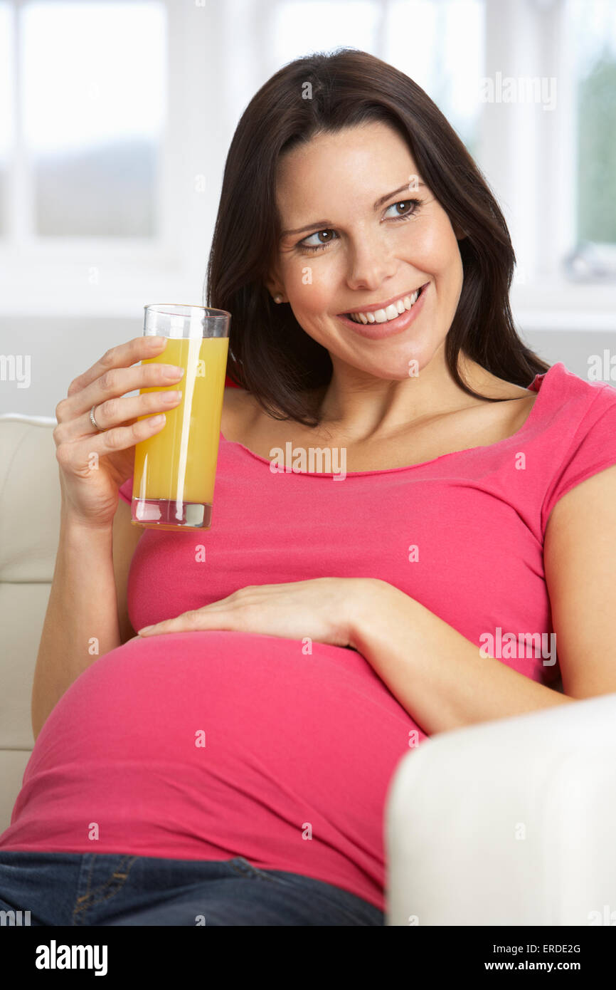 Pregnant Woman Drinking Glass Of Orange Juice At Home Stock Photo - Alamy