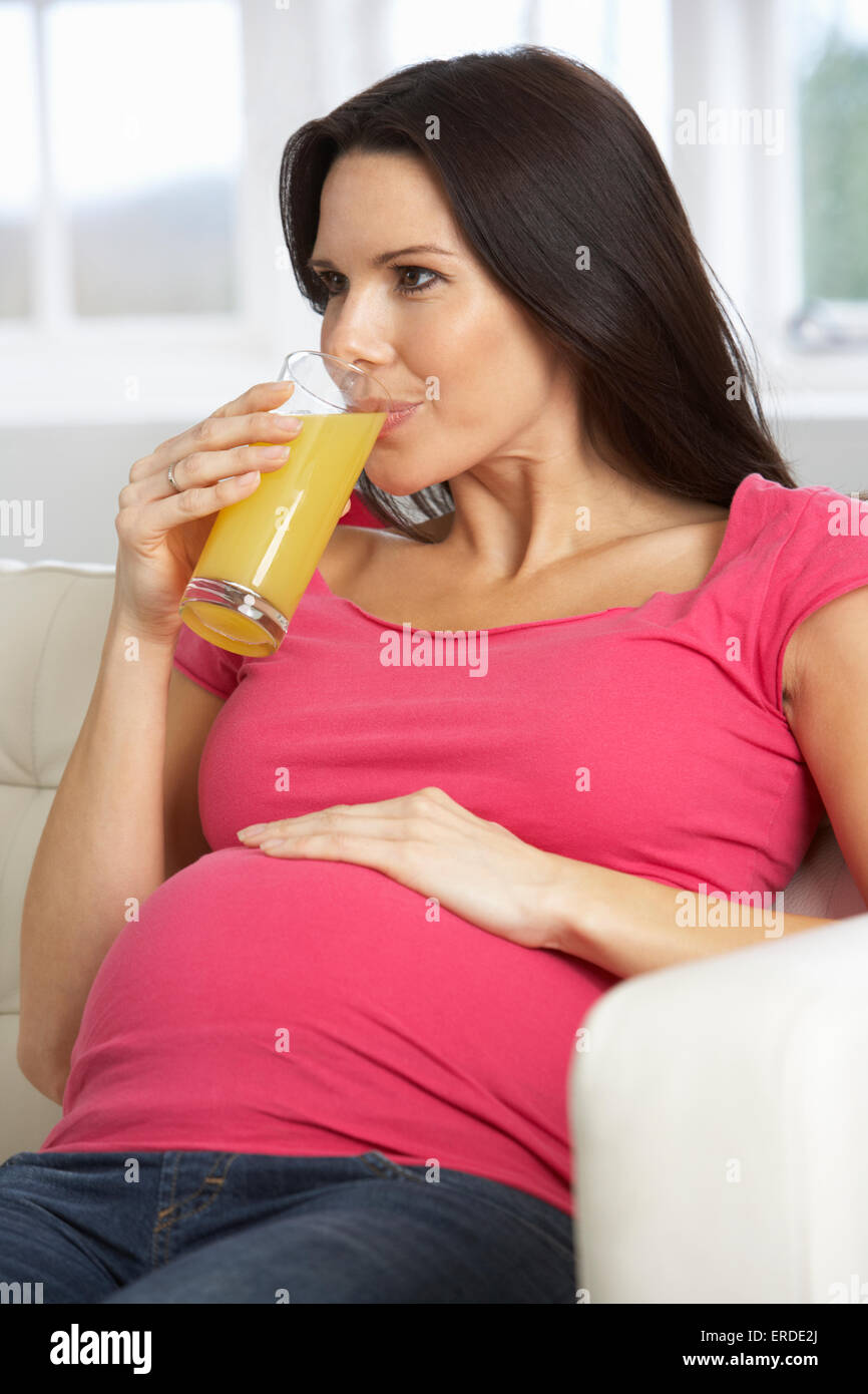 Pregnant Woman Drinking Glass Of Orange Juice At Home Stock Photo - Alamy