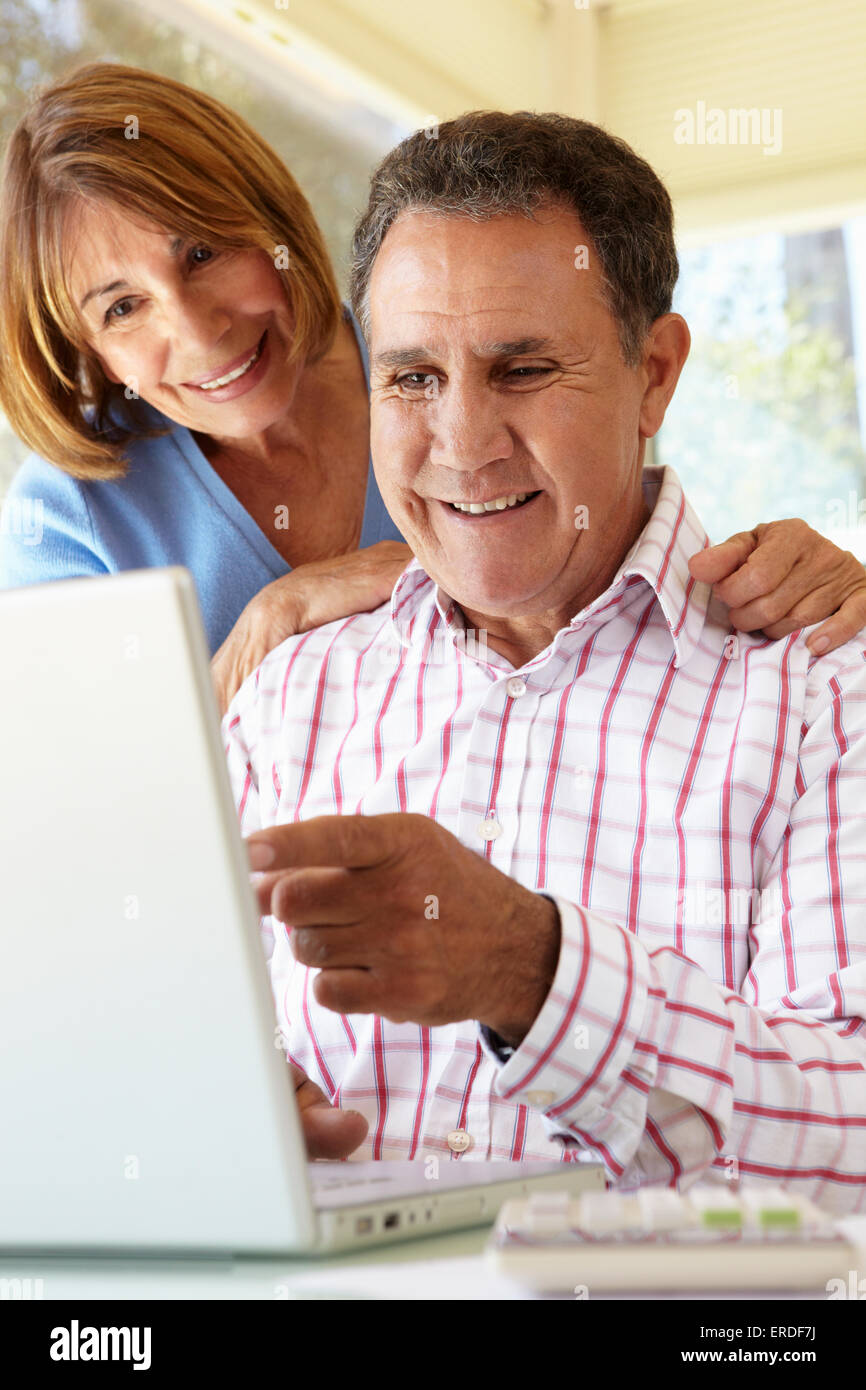 Senior Hispanic Couple Using Laptop In Home Office Stock Photo - Alamy