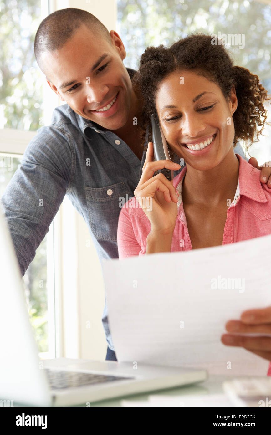 Young Couple Using Laptop At Home Stock Photo - Alamy