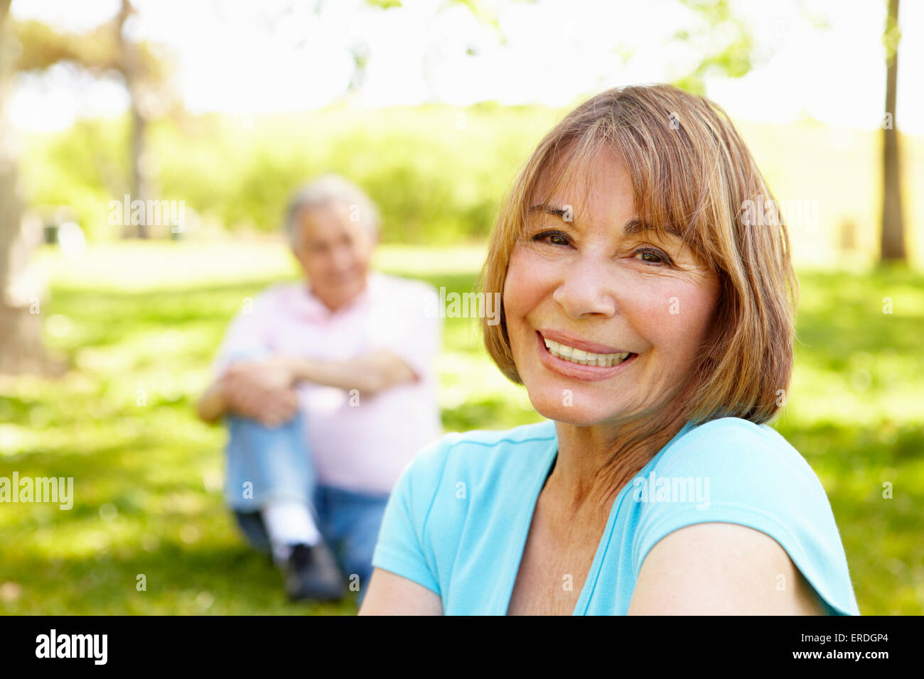 Senior Hispanic Couple Relaxing In Park Stock Photo - Alamy