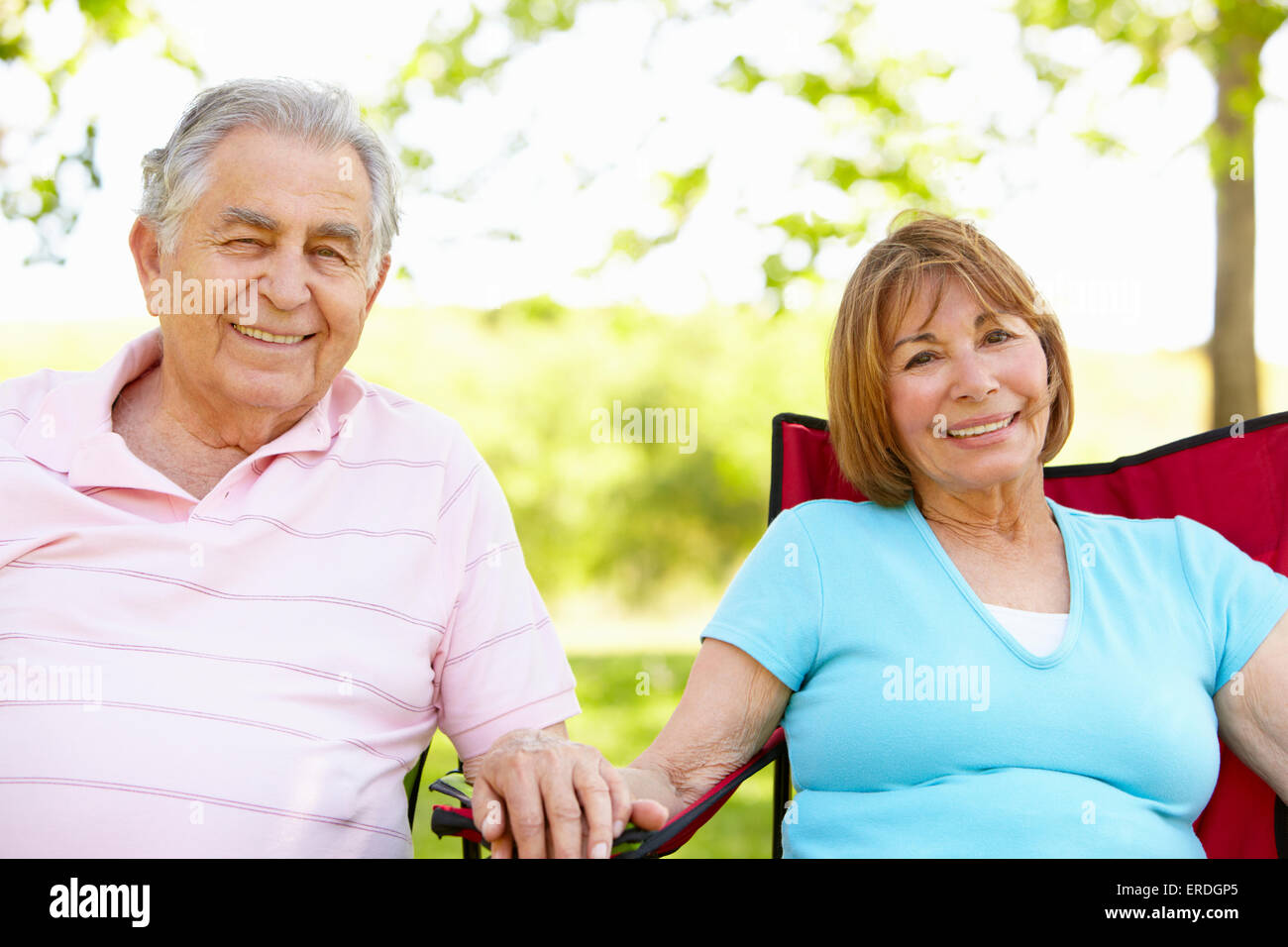 Senior Hispanic Couple Relaxing In Park Stock Photo - Alamy
