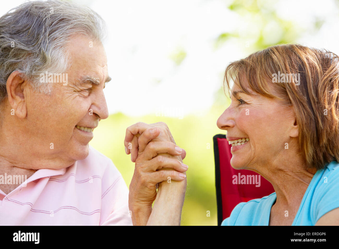 Senior Hispanic Couple Relaxing In Park Stock Photo - Alamy