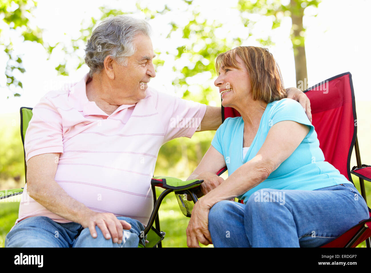 Senior Hispanic Couple Relaxing In Park Stock Photo - Alamy