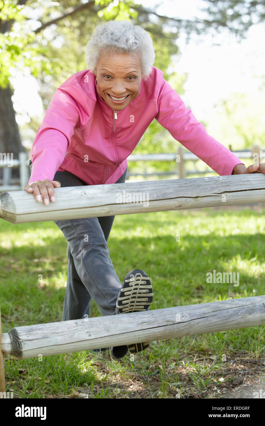 Senior African American Woman Exercising In Park Stock Photo