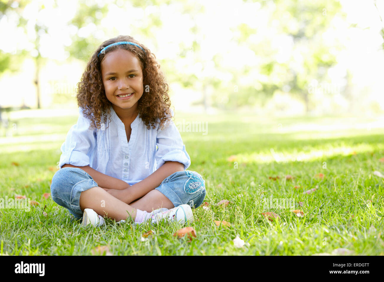 African American Girl Sitting In Park Stock Photo - Alamy
