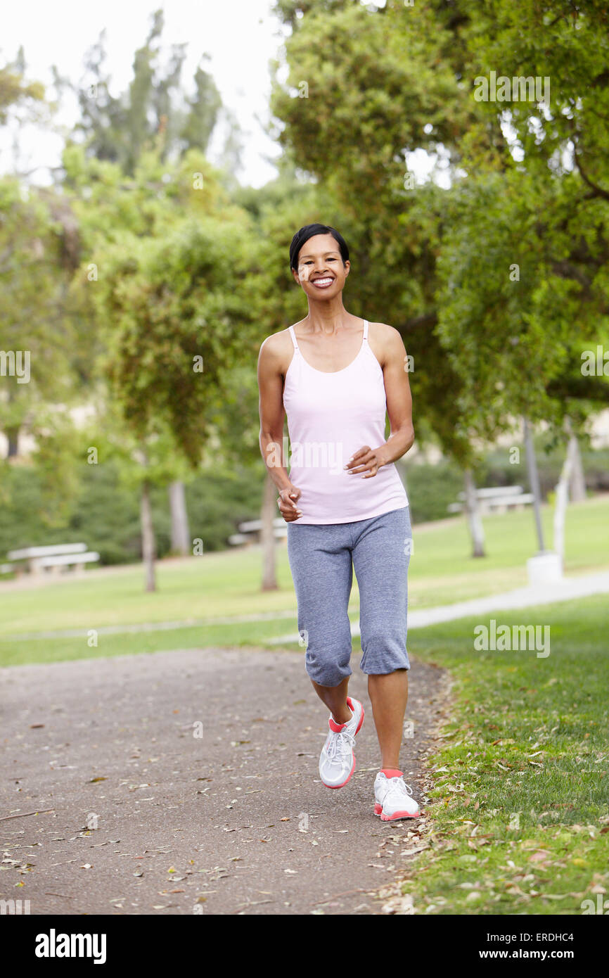 Woman jogging in park Stock Photo Alamy