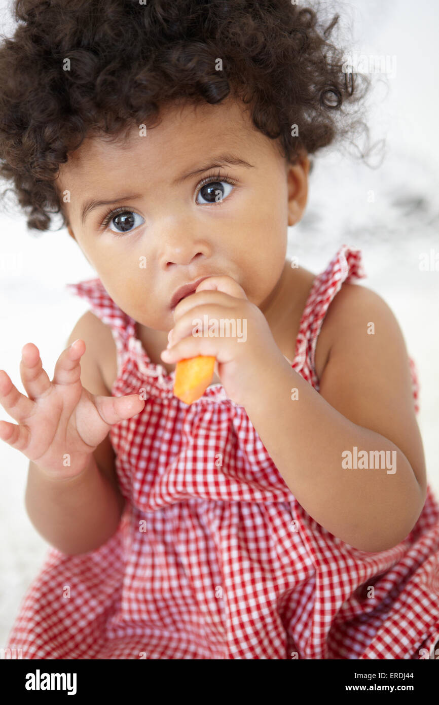 Young Girl Eating Carrot Stick Stock Photo