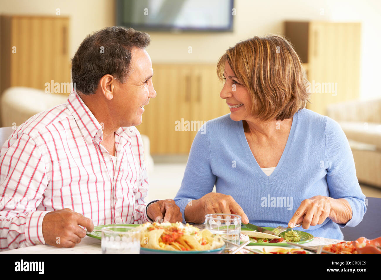 Senior Hispanic Couple Enjoying Meal At Home Stock Photo - Alamy