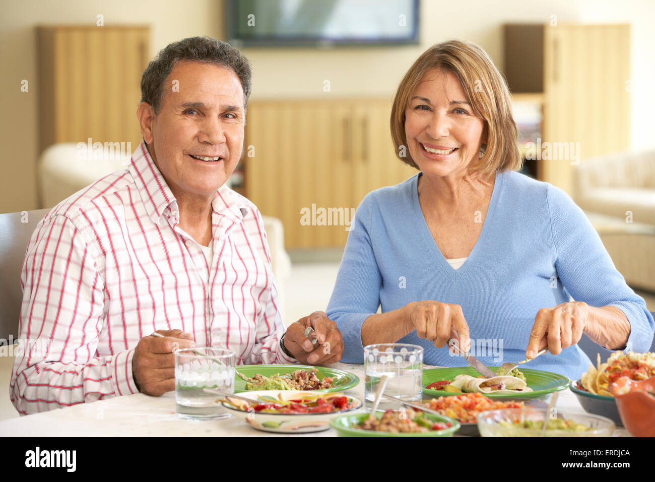 Senior Hispanic Couple Enjoying Meal At Home Stock Photo - Alamy