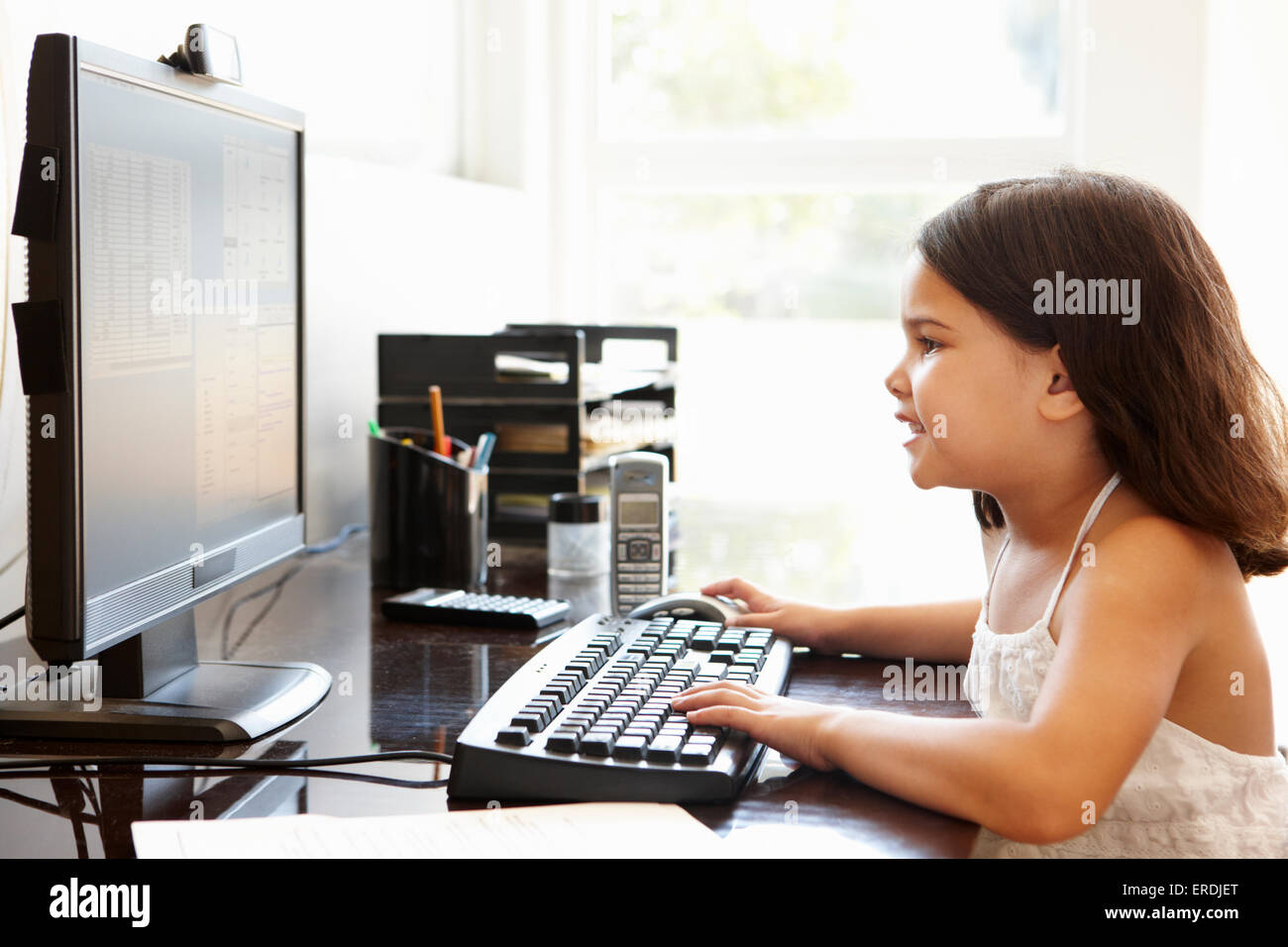 Young Hispanic girl using computer at home Stock Photo - Alamy
