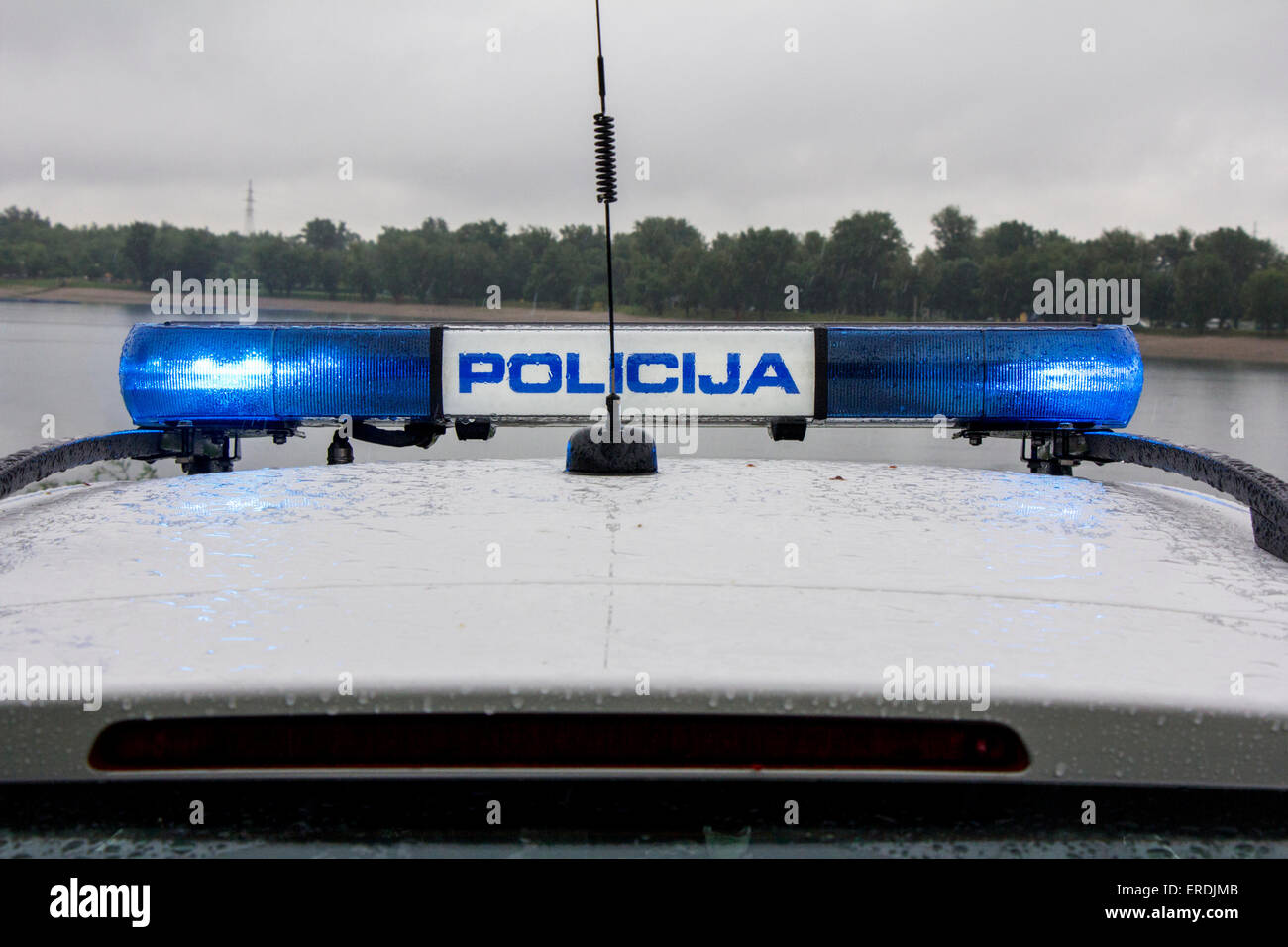 Police car signal siren light, outdoors in the rain Stock Photo