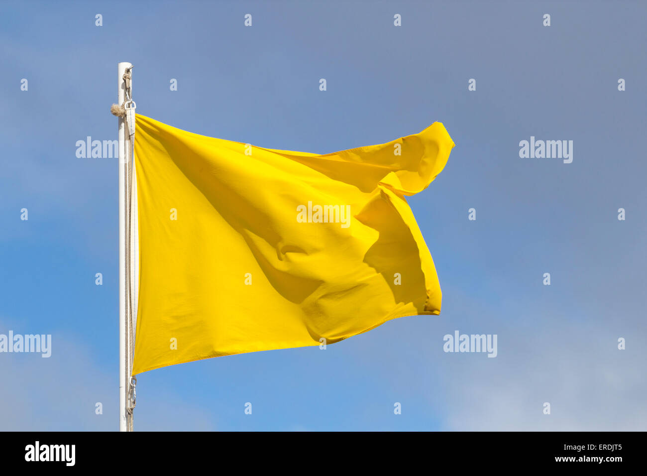 Yellow flag flying on beach Stock Photo Alamy