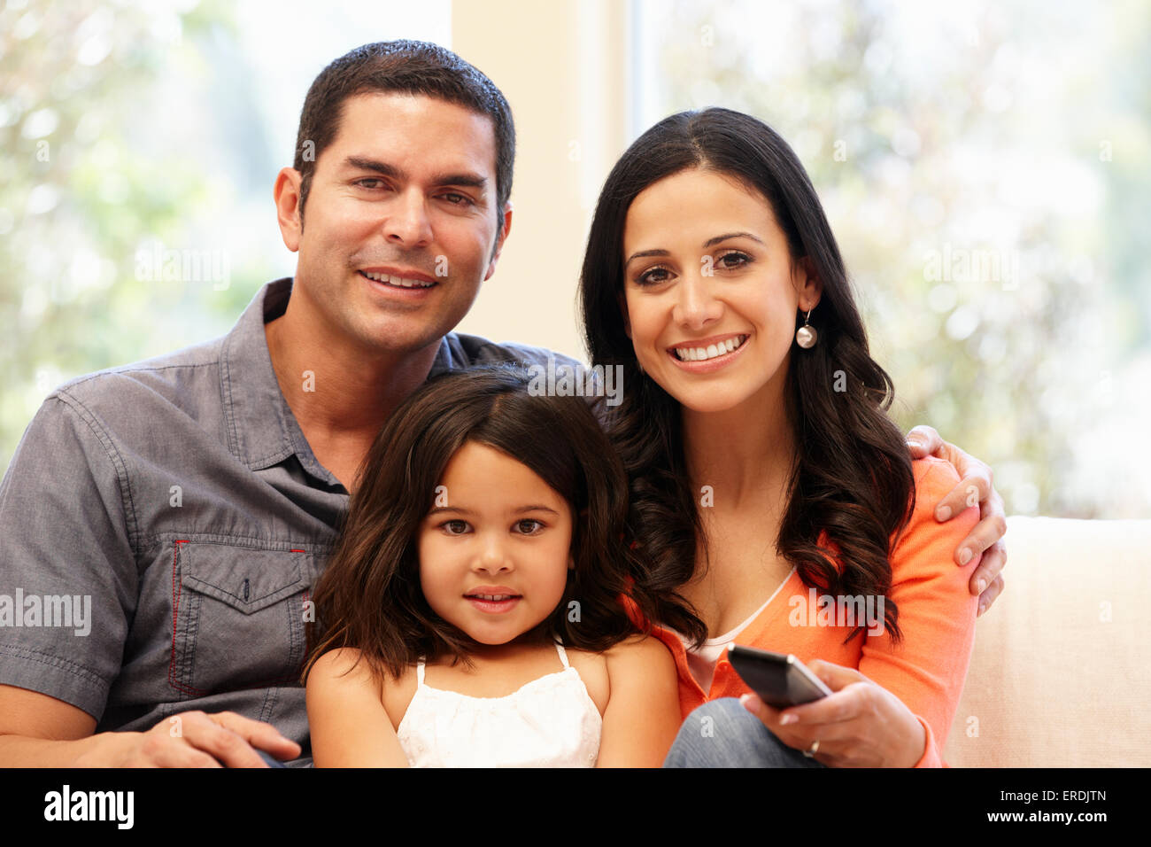 Hispanic family watching television Stock Photo