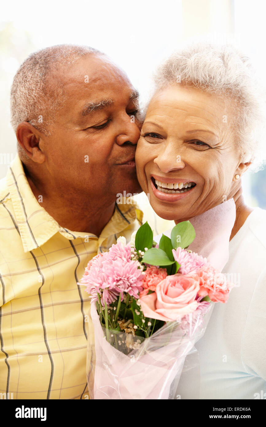 Senior man giving flowers to wife Stock Photo Alamy