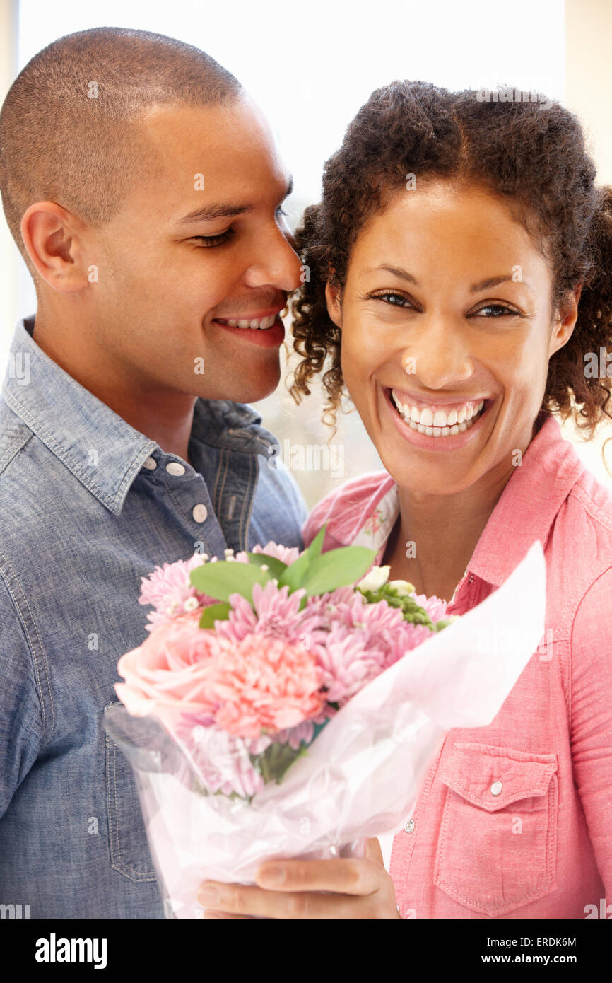 Man giving flowers to woman Stock Photo Alamy