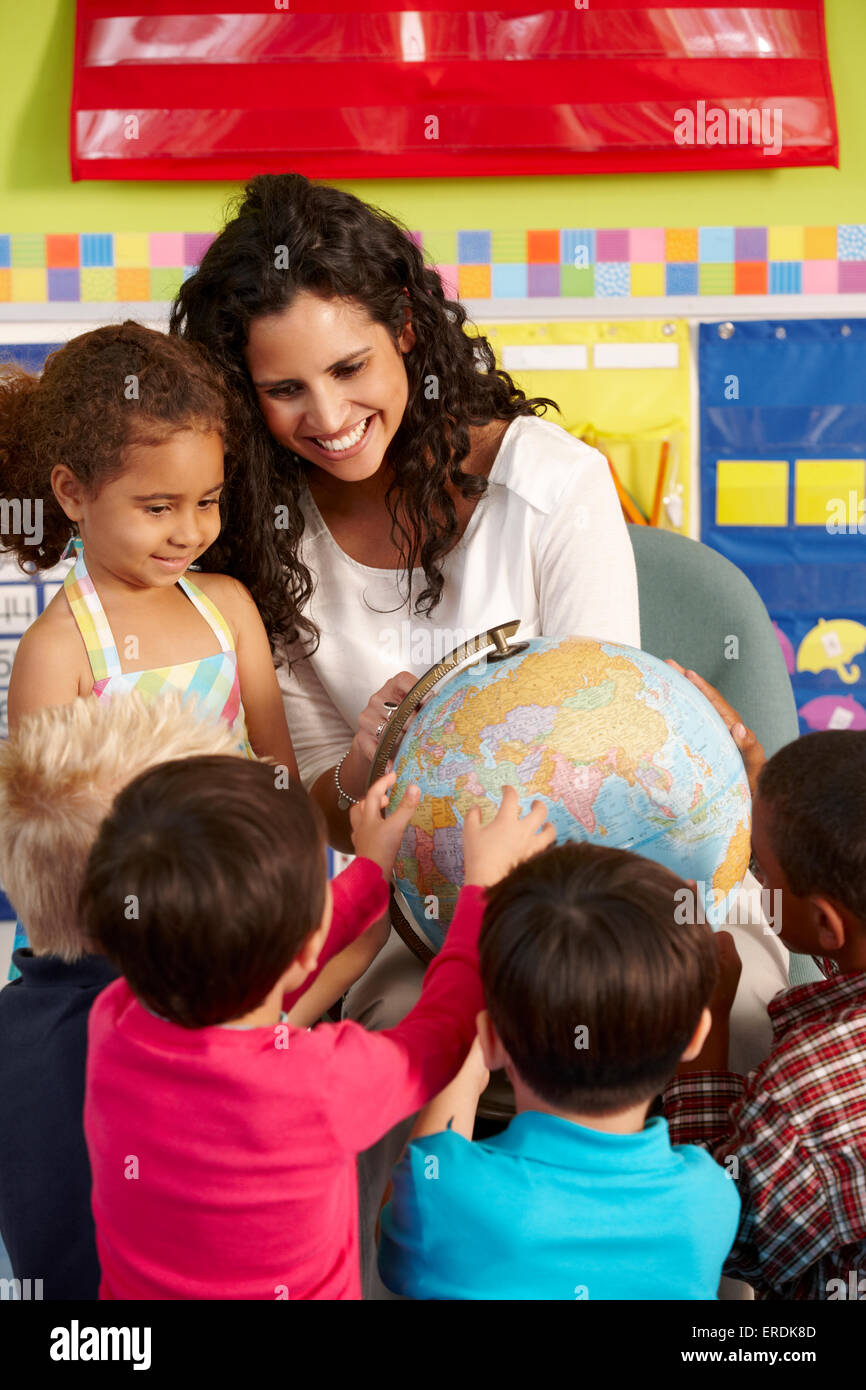 Group Of Elementary Age Schoolchildren In Class With Teacher Stock ...
