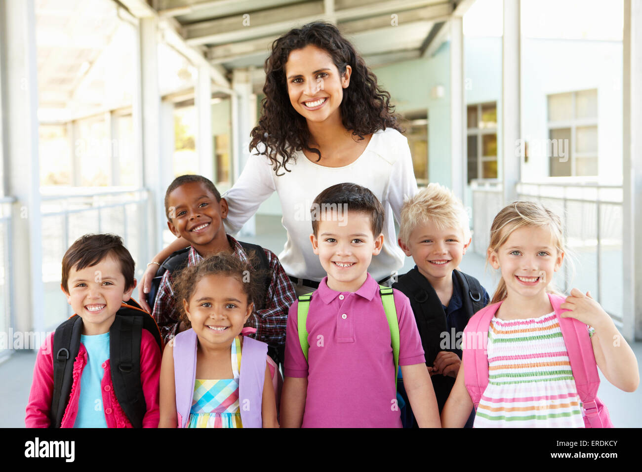 Group Of Elementary Age Schoolchildren Standing Outside With Teacher ...