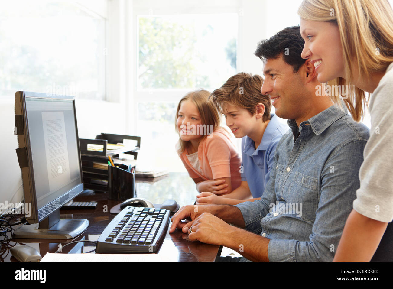 Family with computer in home office Stock Photo - Alamy image.