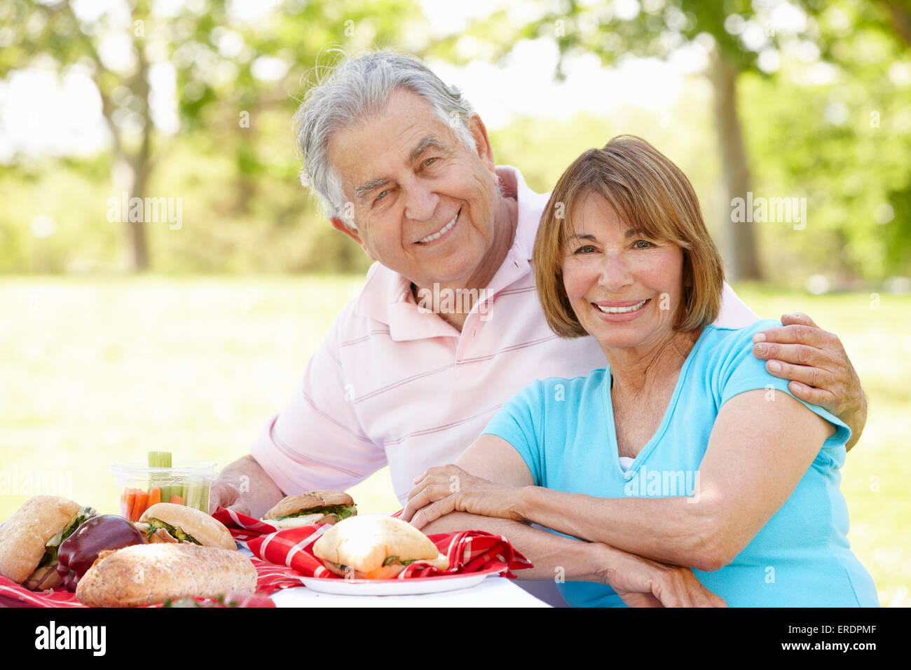 Senior Hispanic Couple Enjoying Picnic In Park Stock Photo - Alamy