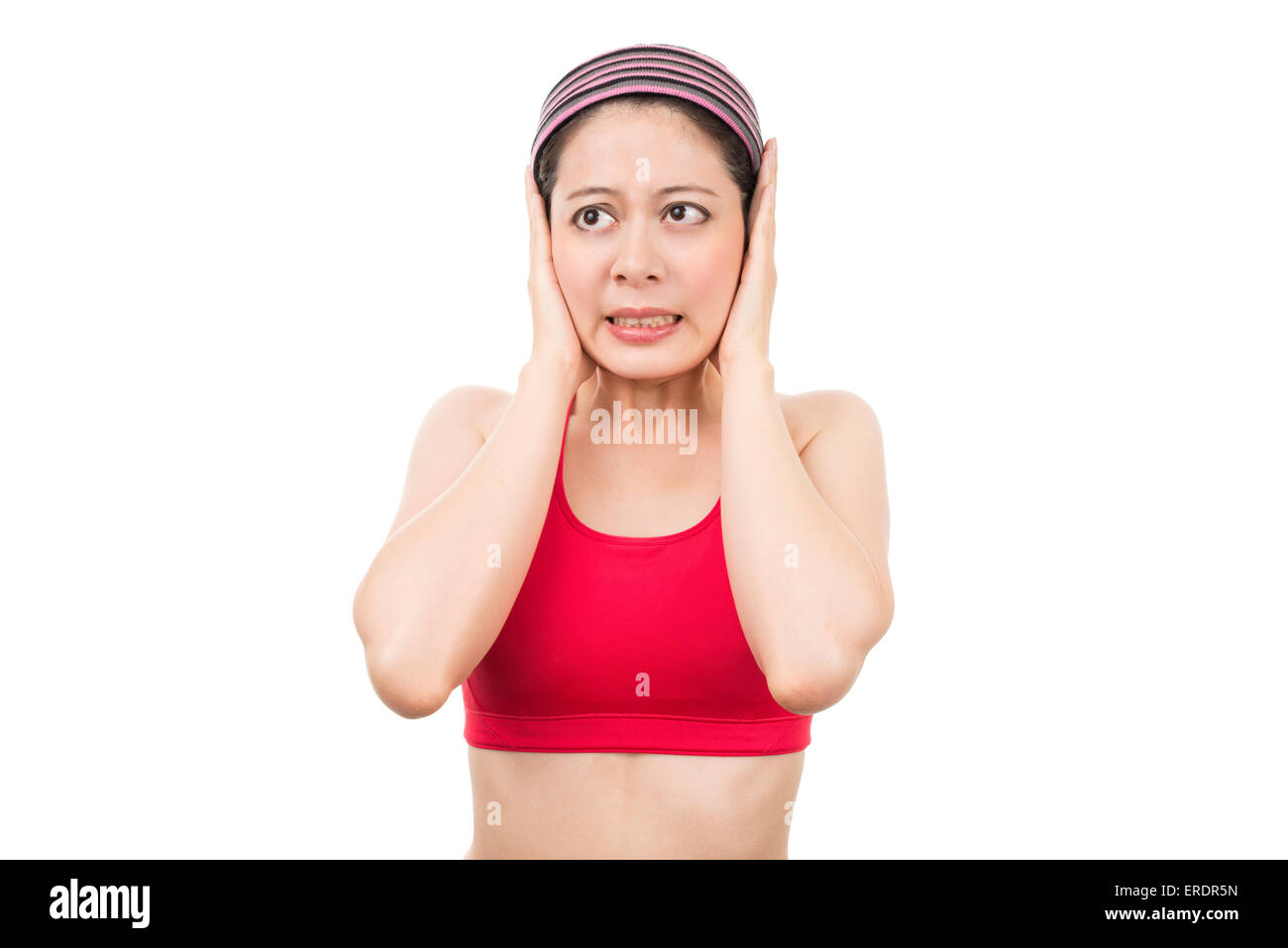 Women blocking out loud noise from ears Stock Photo