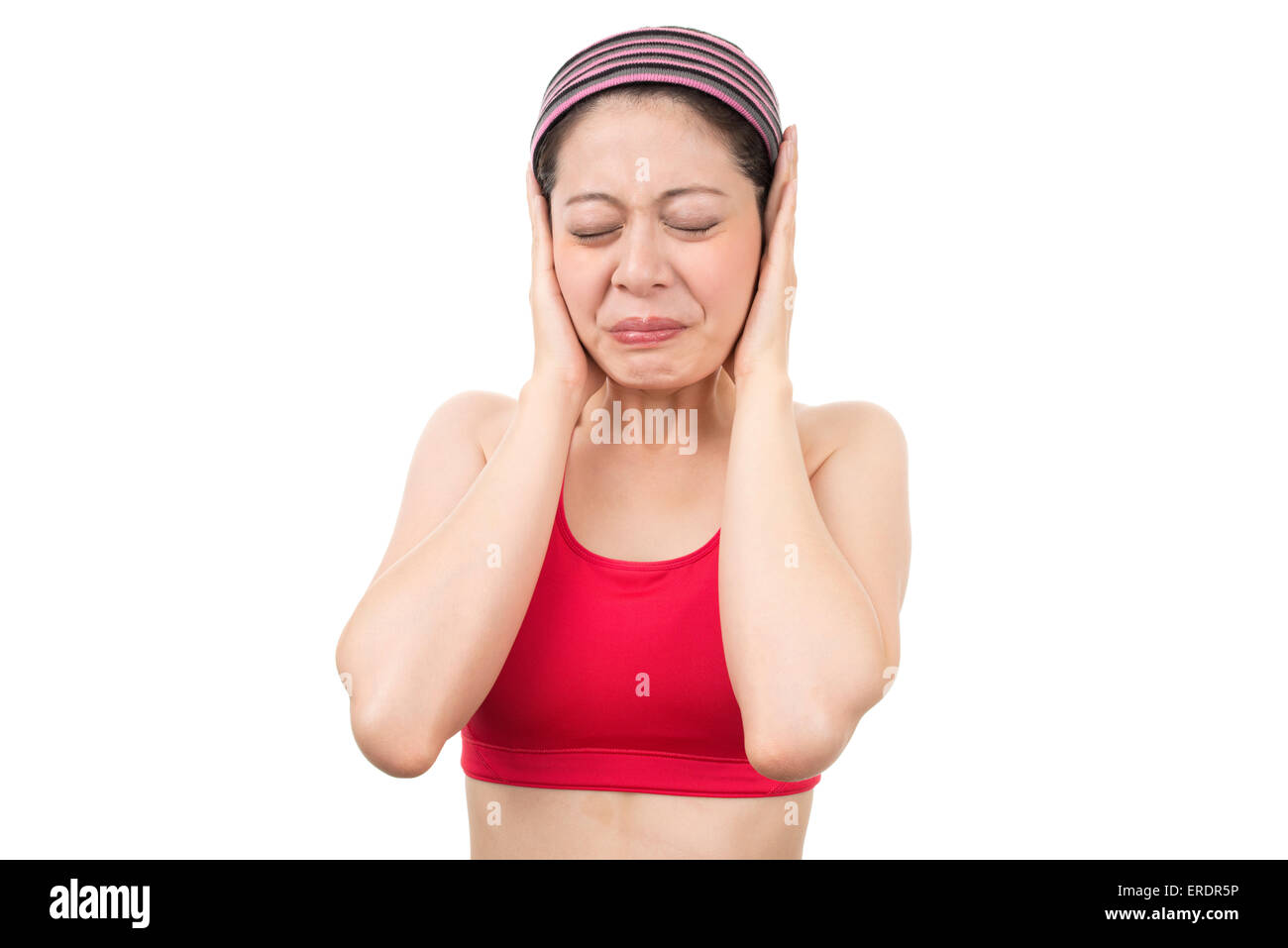 Women blocking out loud noise from ears Stock Photo