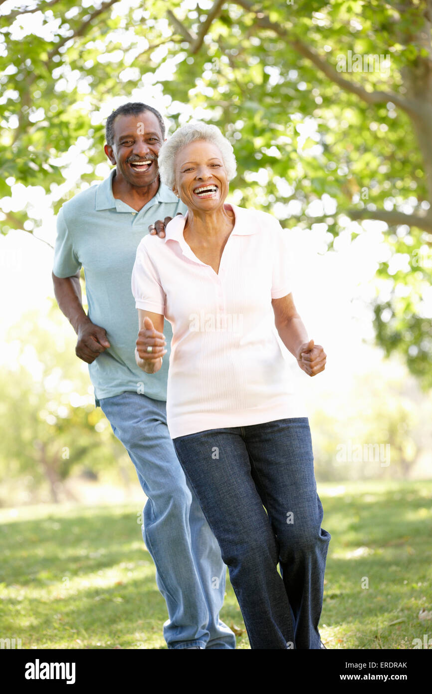 Senior African American Couple Running In Park Stock Photo - Alamy