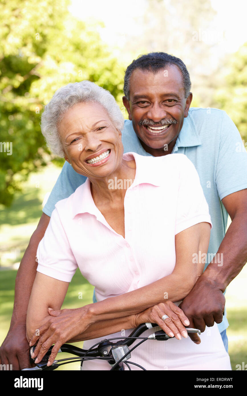 Senior African American Couple Cycling In Park Stock Photo - Alamy