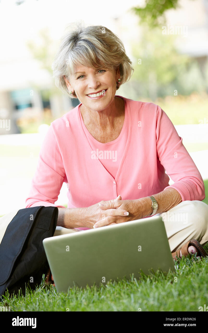 Senior woman using laptop outdoors Stock Photo - Alamy