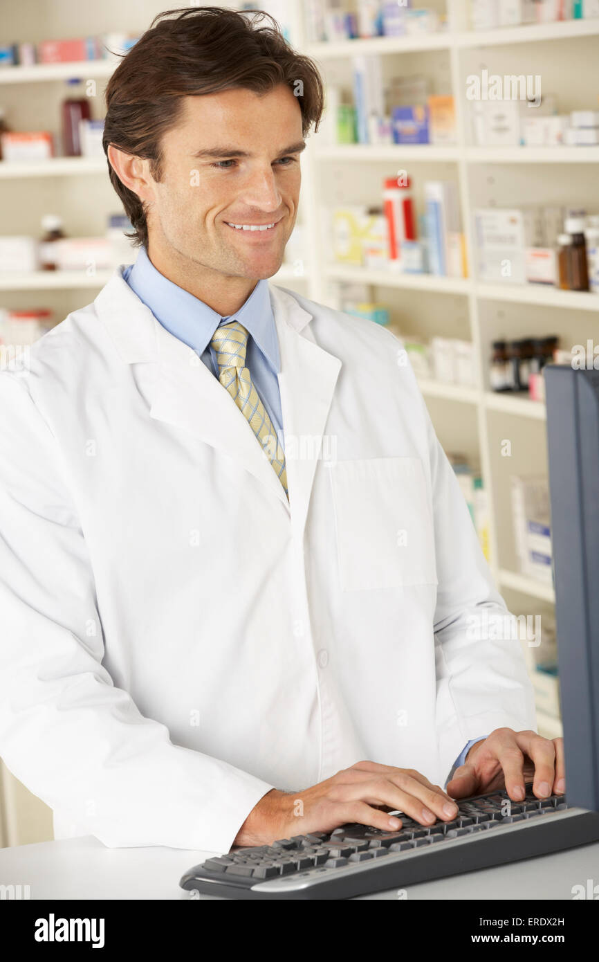 Pharmacist working on computer in pharmacy Stock Photo - Alamy