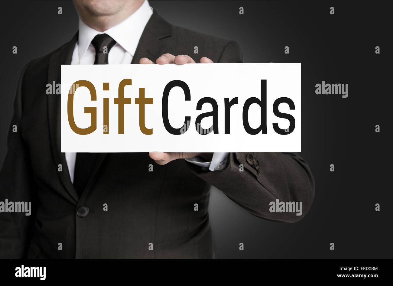 Gift Cards sign is held by businessman. Stock Photo