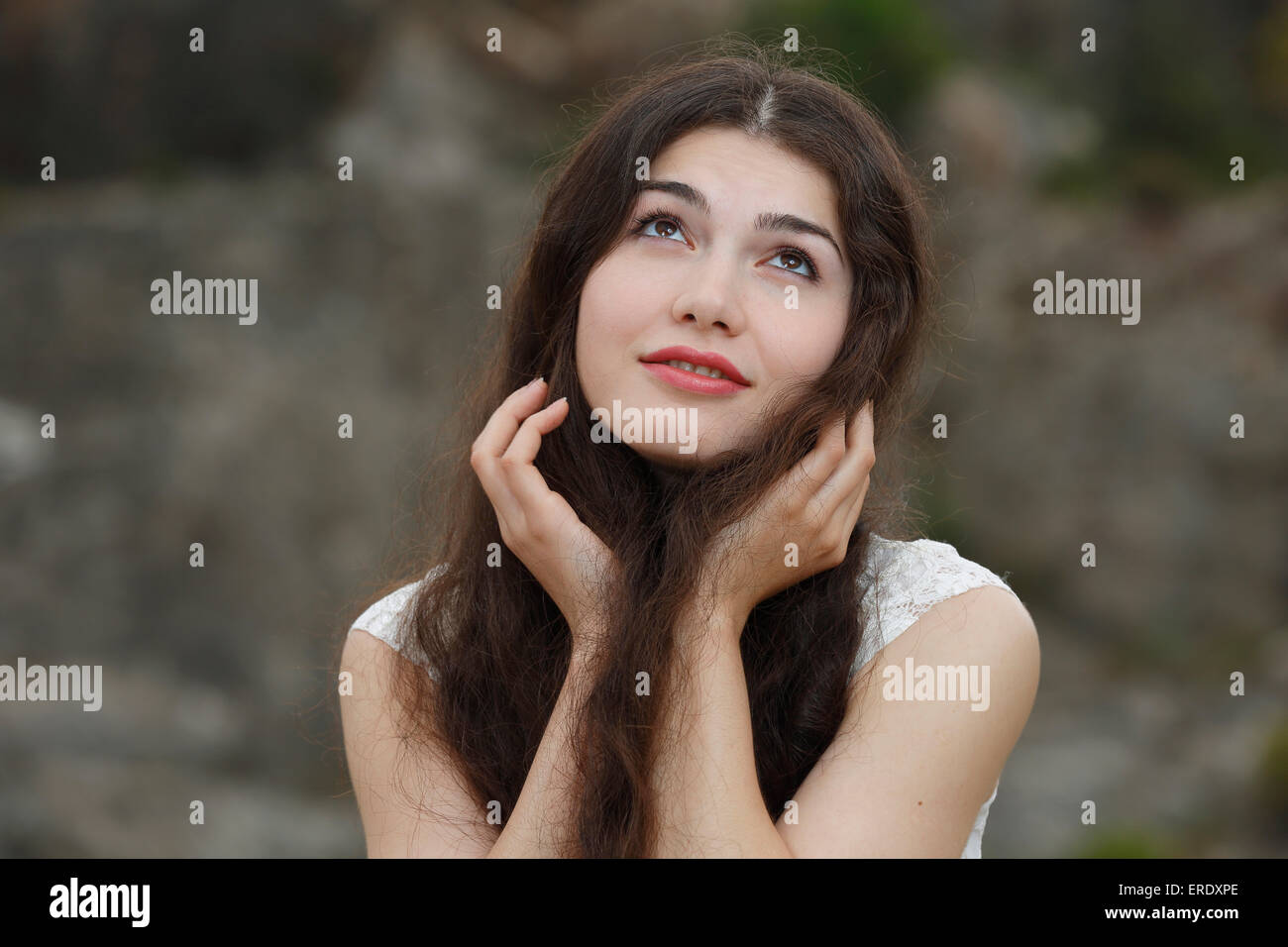 Young woman with long brown hair, misty-eyed Stock Photo